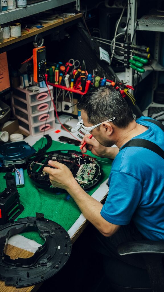 Picture of engineer trying to repair a 3D Printer